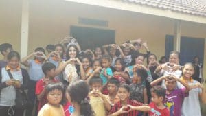Miss Global Surrounded By Children