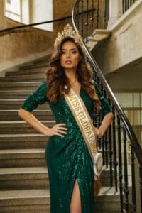 Miss Global in a green gown and a crown